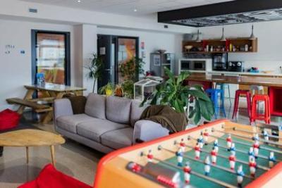 espace détente avec baby-foot canapé cuisine et table à manger - Agrandir l'image 4 sur 6, fenêtre modale